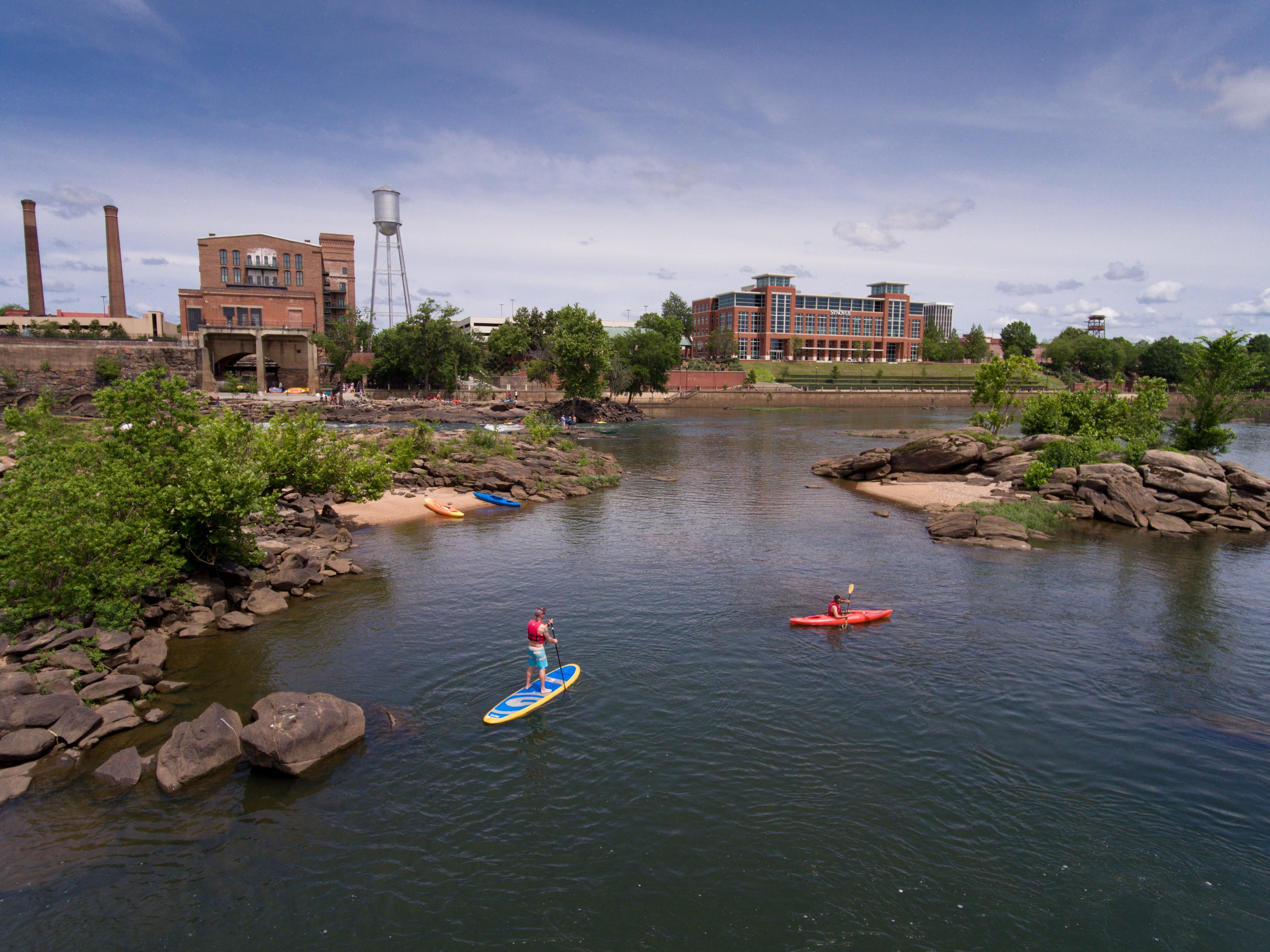 Stand up paddleboarder and canoer on Chattahoochee River in Columbus, Ga.