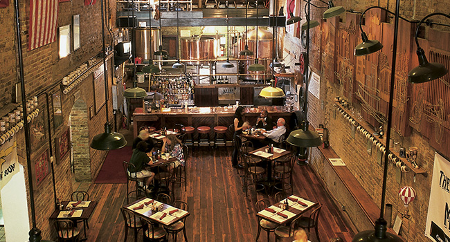 inside of Cannon Brew Pub showing bar, bar stools, and tables