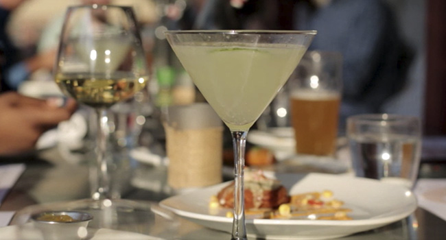 martini glass with cocktail on dinner table in a restaurant
