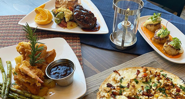 restaurant table with various entrees and appetizers